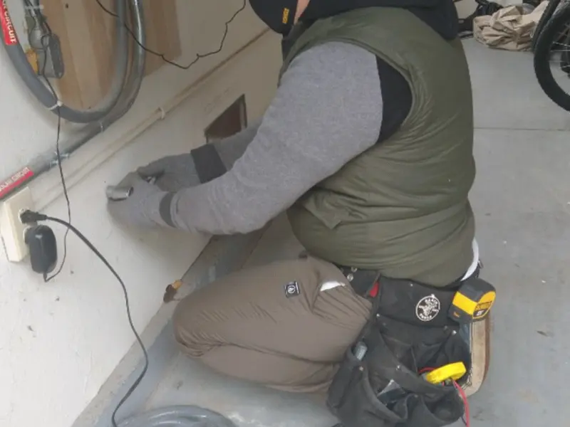 Electrician performing outlet wiring in a Abbeville garage
