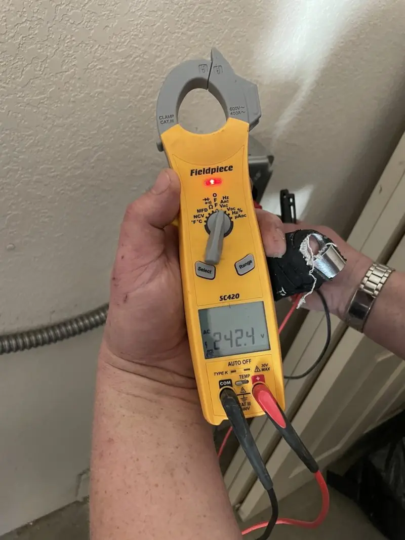Voltage testing with clamp meter during Recessed Lighting Installation in Abbeville